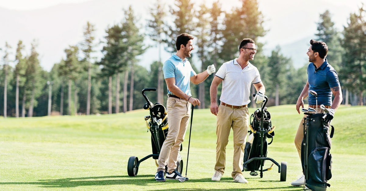 Young men talking on a golf course